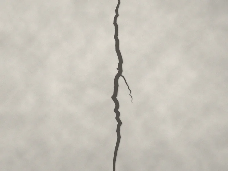 Fissure verticale traversant un mur enduit du haut vers le bas